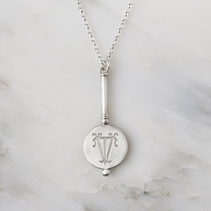 Sterling Silver Initials Monogram Necklace engraved with a two entwined initials and a hidden message engraved on the back