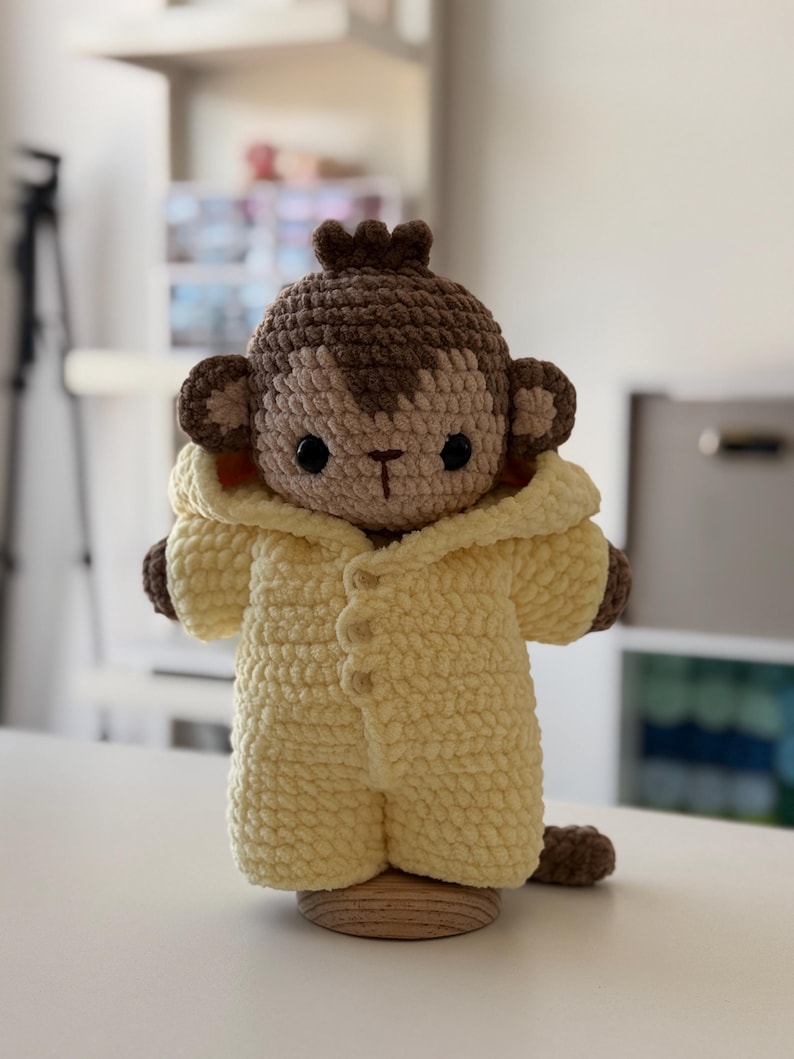 May include: A white ceramic mug with a black handle and the text "But First, Coffee" in a black, handwritten-style font. The mug is on a white surface.