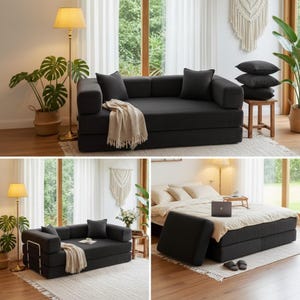 May include: A convertible black sofa in a living room setting. The sofa has two large cushions and two smaller pillows. A beige throw blanket is draped over the sofa. The sofa can be converted into a bed.