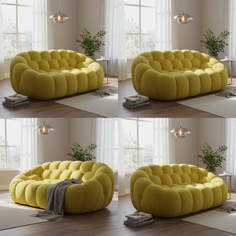 May include: A yellow, bubble-shaped sofa with a rounded design. The sofa is made of a soft, textured fabric and has a modern aesthetic. The room has natural light and is decorated with plants and neutral tones.