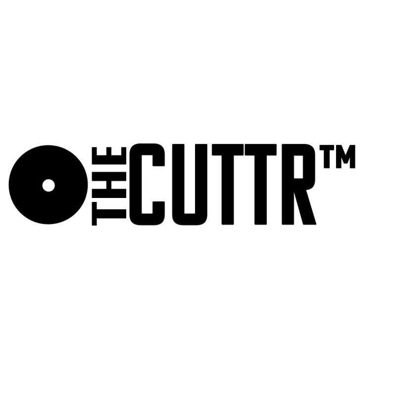 May include: A black graphic logo on a white background featuring a solid black circle with a small white dot in the center, followed by the text THE CUTTR in a bold, sans-serif font, with a trademark symbol positioned to the right of the text.