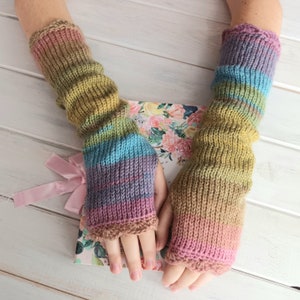 May include: A pair of colorful knitted fingerless gloves with a multi-colored striped pattern. The gloves are made of a soft, warm yarn and have a ribbed texture.