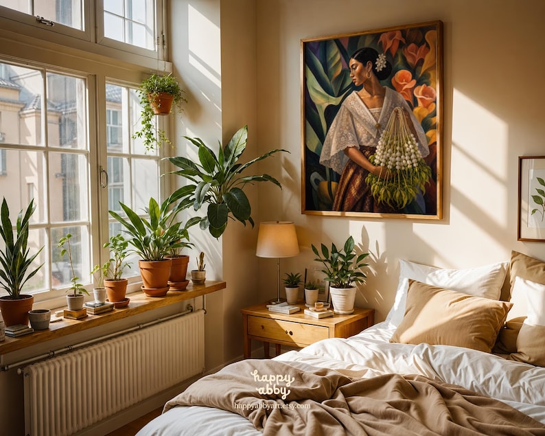May include: A bedroom interior featuring a large framed painting of a person in traditional attire holding a bouquet of white flowers. The room includes a wooden nightstand with a lamp, a bed with tan bedding, and a window sill filled with potted plants.
