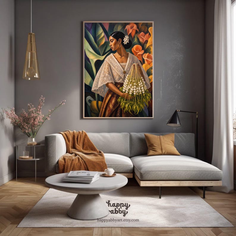 May include: A framed wall art print depicting a person in a white lace blouse and brown skirt holding a bundle of white flowers against a backdrop of large green leaves and orange blossoms. The text happy abby and happyabbyart.etsy.com is visible.