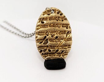 Golden Bronze Necklace with Engraved Phrases.