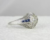 Ornate Platinum Filigree Engagement Ring. Diamonds & Sapphires in Art Deco Platinum Filigree, Circa 1920s.