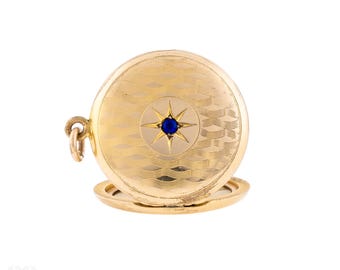 Vintage-Medaillon aus gerolltem Gold mit Sternenmuster und guillochiertem Dekor sowie Saphirpaste.