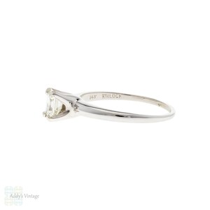 May include: A 14k white gold engagement ring with an emerald cut diamond. The ring is marked "Kinloca" on the inside of the band.