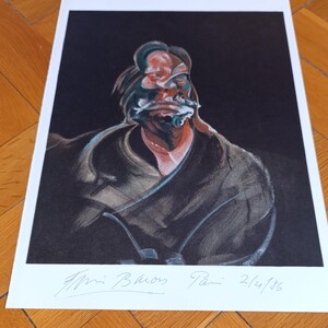May include: A framed print of a Francis Bacon painting. The artwork features a distorted portrait against a dark backdrop. The signature and date, 2/4/86, are visible at the bottom. The colour palette includes black, red, and white.
