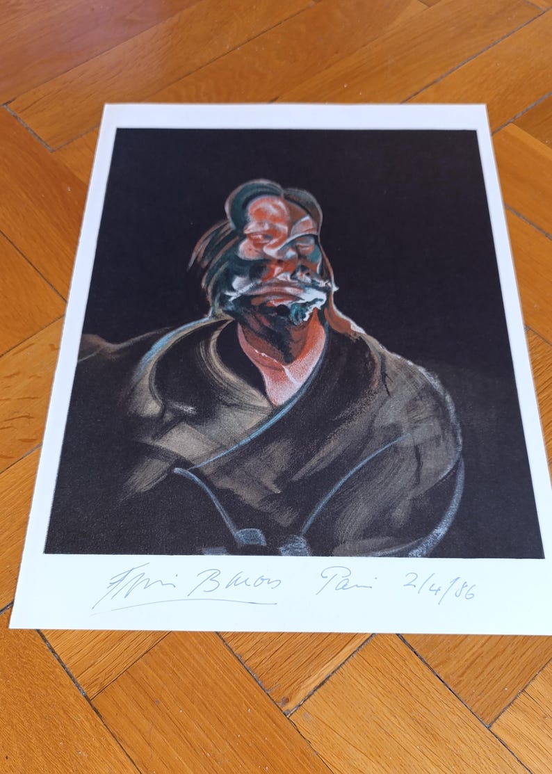 May include: A framed print of a Francis Bacon painting. The artwork features a distorted portrait against a dark backdrop. The signature and date, 2/4/86, are visible at the bottom. The colour palette includes black, red, and white.