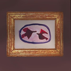 Puede incluir: Pintura abstracta de dos pájaros en vuelo, representados en tonos rojos y marrón oscuro sobre un fondo rosa, encerrados en un óvalo morado. La obra está enmarcada en un marco de madera dorada envejecida.