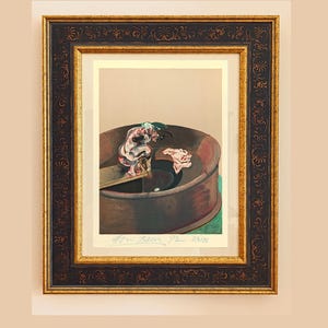 May include: Framed artwork featuring a painting of a figure in a circular structure. The artwork is in a dark brown frame with gold accents. The painting has a muted color palette with a signature and edition number visible.