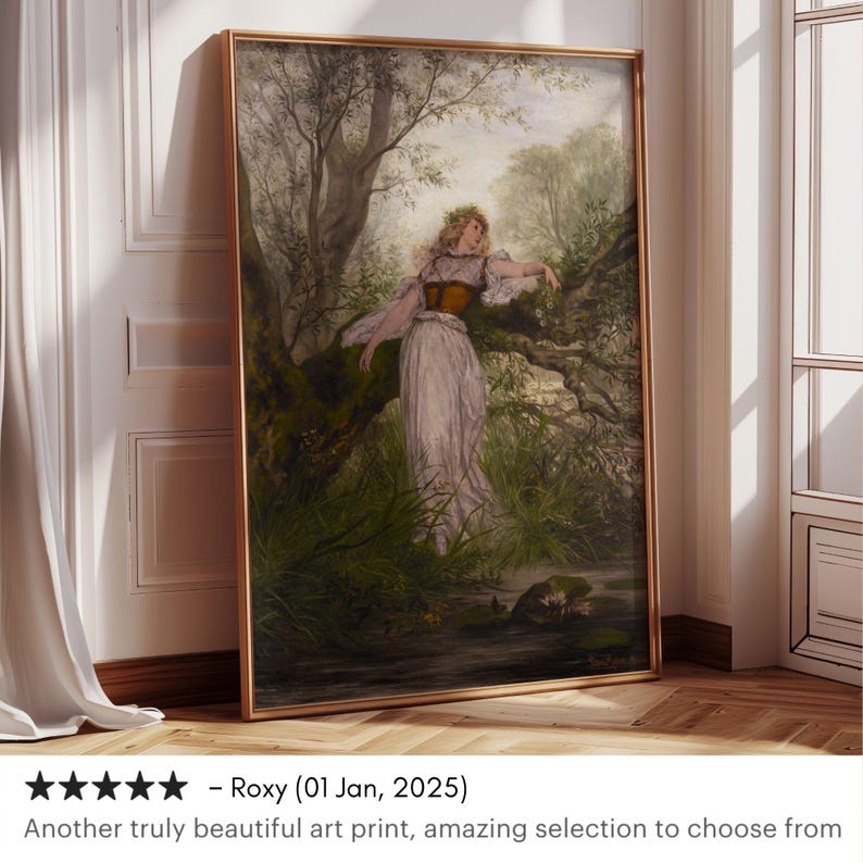 May include: A framed vertical art print featuring a painting of a person with long hair wearing a light-colored dress and a dark corset, standing in a lush, green forest setting near a stream. The artwork is enclosed in a thin, metallic gold frame.
