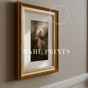 May include: A framed art print titled DAHL PRINTS featuring a figure in a long dress standing in a wooded landscape. The artwork is enclosed in an ornate gold frame with a white mat. A circular watermark reads 100% AUTHENTIC VINTAGE ART.