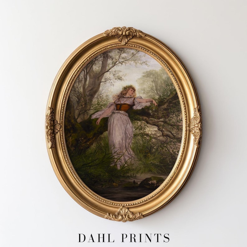 May include: An oval gold-toned frame with ornate detailing surrounds a print of a person in a light-colored dress and dark corset standing in a wooded area near a stream. The text DAHL PRINTS is visible at the bottom of the image.