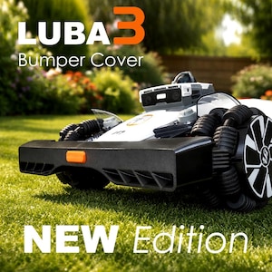 May include: A black bumper cover for a Luba 3 robotic lawn mower, featuring a prominent orange rectangular accent on the front. The device has large, multi-segmented wheels and a white chassis with a camera sensor module. Text reads LUBA 3 Bumper Cover NEW Edition.