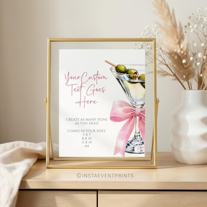 Può includere: Un cartello rettangolare in una cornice dorata con un'illustrazione ad acquerello di un bicchiere da martini con olive e un nastro rosa. Il testo recita: Your Custom Text Goes Here, CREATE AS MANY SIGNS AS YOU NEED, COMES IN FOUR SIZES: 5 X 7, 8 X 10, 11 X 14, A4.