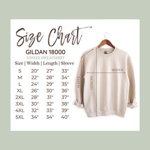 May include: A cream-colored Gildan 18000 unisex sweatshirt displayed on a hanger. The image includes a size chart with measurements in inches for sizes S through 5XL, detailing width, length, and sleeve length. The text "Size Chart" is at the top.
