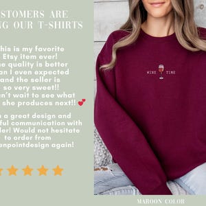 May include: Maroon sweatshirt with the text "Wine Time" and a wine glass graphic. The sweatshirt also has the text "Customers are loving our T-shirts".