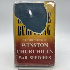 May include: A vintage book titled "The Beginning" by Winston Churchill. The cover is yellow, red, and blue with text. The book is the third volume of Churchill's War Speeches. The book is in a plastic cover.