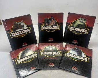 May include: A collection of six Jurassic Park hardback books featuring dinosaur illustrations and titles including Triceratops, Dilophosaurus, Velociraptor, Brachiosaurus, Jurassic Park The Great Adventure, and Gallimimus, all with black and red covers.