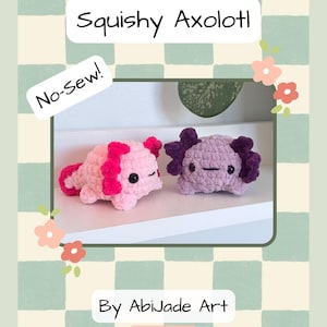 May include: A crochet pattern titled "Squishy Axolotl" featuring two handmade axolotl plushies. One is pink with magenta accents, the other is purple. The pattern is labeled "No-Sew!" and is by Abijade Art.