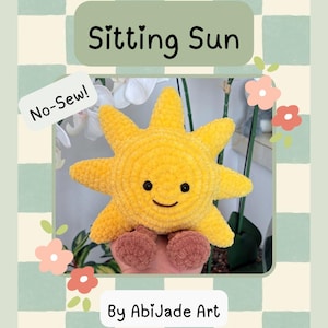 May include: A yellow plush sun toy with a round face, black eyes, and a stitched smile, featuring eight pointed rays and two small brown feet. The image includes text reading PDF Crochet Pattern, Sitting Sun, No-Sew!, and By AbiJade Art.