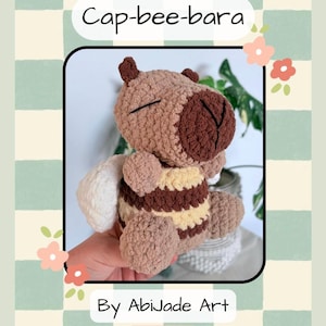 May include: Crochet pattern for a Cap-bee-bara plushie. The plushie is a combination of a capybara and a bee, with brown, tan, and cream colors. The pattern is by Abijade Art.