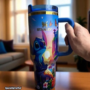 May include: A dark blue Stanley tumbler featuring a cartoon character design. The tumbler has a blue handle and lid, with gold accents. The design includes the text "Dark Blue Design" and "SpeciallyCrafted".