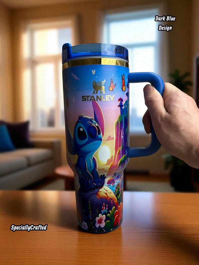 May include: A dark blue Stanley tumbler featuring a cartoon character design. The tumbler has a blue handle and lid, with gold accents. The design includes the text "Dark Blue Design" and "SpeciallyCrafted".