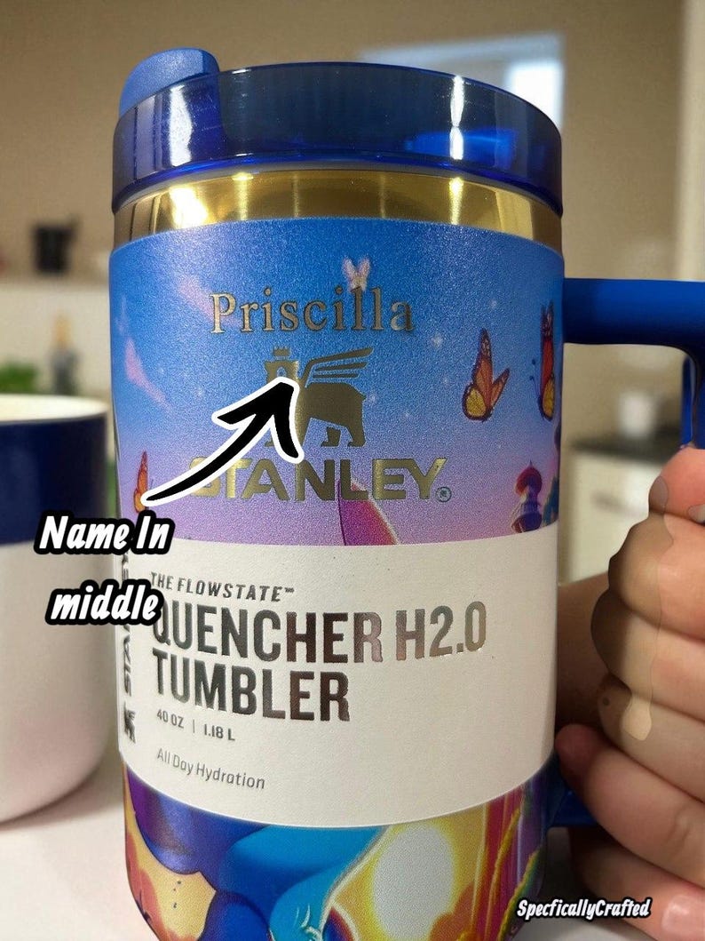 May include: A blue and gold Stanley Quencher H2.0 tumbler with a handle. The tumbler has the name "Priscilla" printed on it, along with the Stanley logo and the words "QUENCHER H2.0 TUMBLER". It holds 40 oz (1.18 L).