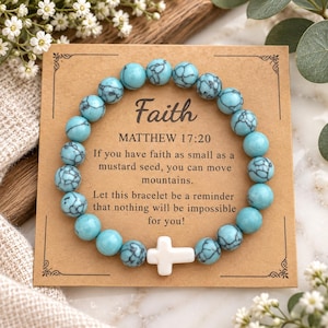 May include: A circular bracelet made of turquoise-colored beads with black veining and a single white cross-shaped bead. The bracelet is displayed on a square tan card featuring the text Faith, Matthew 17:20, and an inspirational quote.