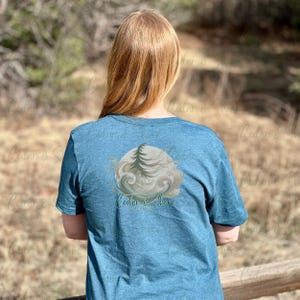 ヘザーディープティールTシャツ背面モックアップ | Bella Canvas 3001 | 自然背景 | デジタルダウンロード | 自然ライフスタイルにおけるリアルモデル