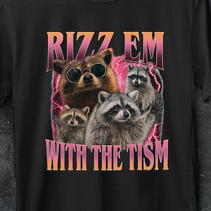 May include: Black t-shirt with a graphic of raccoons wearing sunglasses and the text "RIZZ EM WITH THE TISM". The design has a retro style. The image also includes a "50% OFF" promotion. The shirt has a round neck and short sleeves.