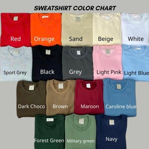 May include: A sweatshirt color chart displaying fifteen crewneck sweatshirts in various colors including red, orange, sand, beige, white, sport grey, black, grey, light pink, light blue, dark choco, brown, maroon, caroline blue, forest green, military green, and navy.