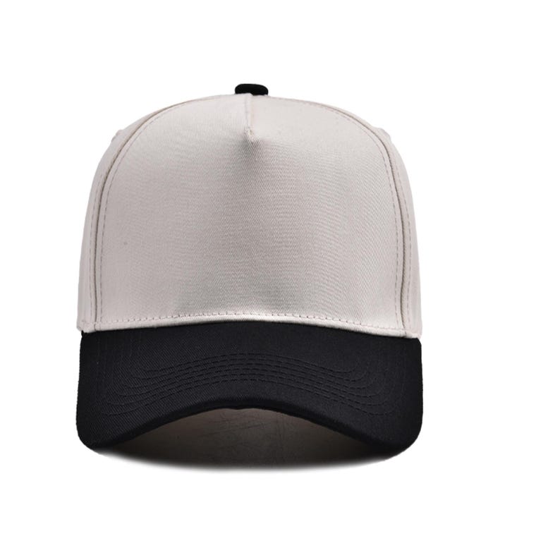 May include: A two-tone baseball cap with a white crown and a black brim. The cap has a structured design with a curved brim and a small black button on top. This hat is a classic accessory.