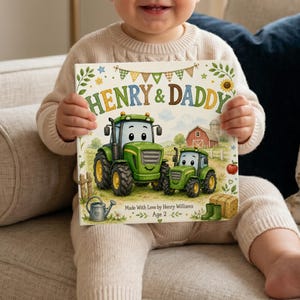 Könnte beinhalten: Ein Kinderbuch mit dem Titel "HENRY & DADDY" mit Illustrationen von grünen Traktoren, einer roten Scheune und einem Heuballen. Das Buch wird von einem Kind gehalten. Der Text "Made With Love by Henry Williams Age 2" ist ebenfalls sichtbar.