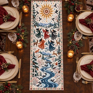 May include: A rectangular table runner featuring a winter scene with a golden sun, flying birds, dancing figures in colorful dresses, deer, a fox, and a winding blue river through a snowy forest, bordered by a pattern of red berries and leaves.