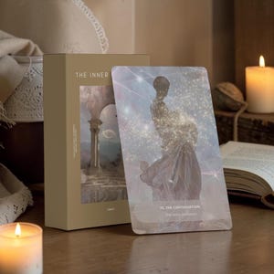 May include: A rectangular tan box labeled THE INNER with a tarot card leaning against it. The card features a celestial figure composed of shimmering light and stars, titled 70. THE CONTINUATION, the story continues, set against a soft, ethereal background.