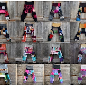 May include: A collection of 16 pairs of colourful patchwork baby leggings. The leggings are made from a variety of recycled fabrics, including sweaters, socks, and t-shirts. Each pair is unique and features a different combination of colours and patterns.