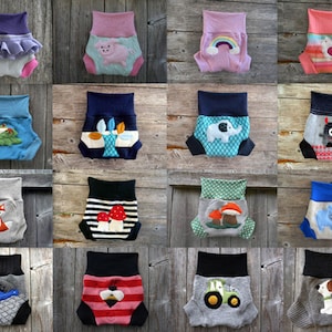 Może przedstawiać: Kolekcja 16 kolorowych pieluch materiałowych z r&oacute;żnymi wzorami inspirowanymi zwierzętami i naturą. Każda pielucha ma inny wz&oacute;r, w tym lisa, żabę, grzyba, traktor, psa, dinozaura, pszczołę, słonia, tęczę, ptaka, potwora i jeża.