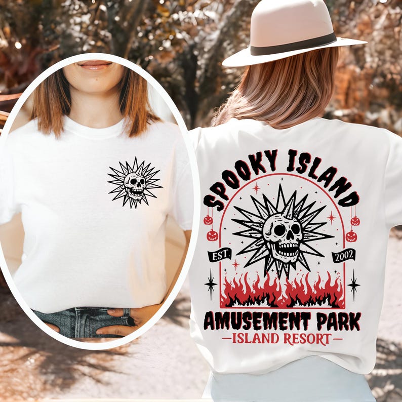 May include: White t-shirt featuring a black skull design with radiating lines on the front and back. The back design includes the text "Spooky Island Amusement Park - Island Resort" with a skull and flame graphic.