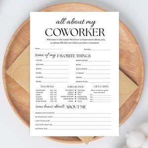 May include: A white fill-in-the-blank questionnaire titled "all about my COWORKER" with prompts for favorite things and bonus details. The paper is on a wooden plate with a brown envelope.
