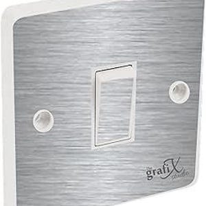 May include: A brushed silver light switch cover with a white border and the text "the grafix studio" in black.