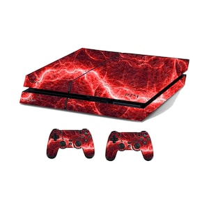 May include: A PlayStation 4 console and two matching controllers. The console and controllers are covered in a red and white lightning bolt design. The console is black with the PS4 logo on the front. The controllers have the standard button layout.