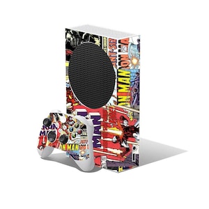 May include: A white gaming console and controller set with a comic book design. The console has a black circular vent and is covered in colourful comic book panels with "Iron Man" visible. The controller has a similar comic book design.