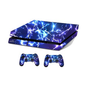 May include: A PlayStation 4 console and two matching controllers, all featuring a vibrant blue and purple lightning bolt design. The console has the text "PS4" and "grafix" on it.