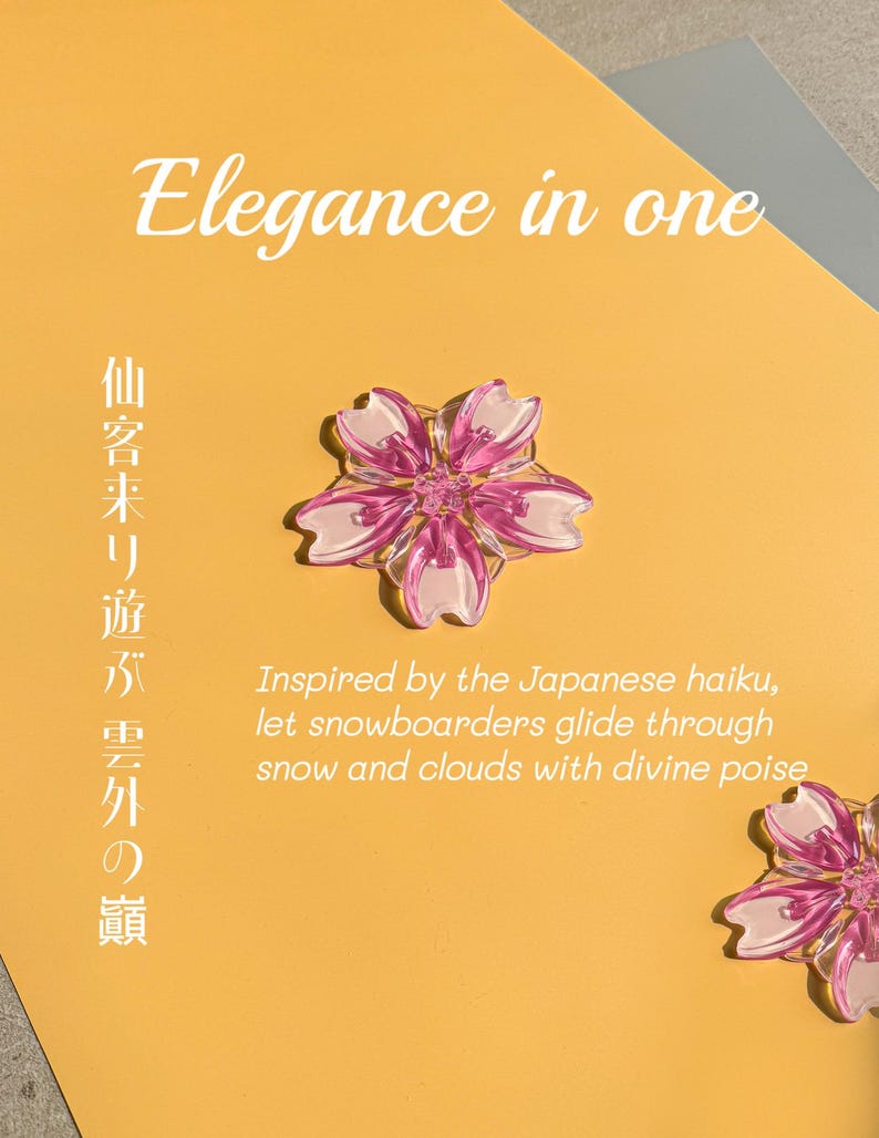 May include: A close-up of a yellow card with the text "Elegance in one" and Japanese characters. A pink and white flower-shaped object is in the center. The text "Inspired by the Japanese haiku, let snowboarders glide through snow and clouds with divine poise" is also visible.