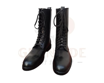 May include: A pair of black leather combat boots. The boots are tall, with a lace-up design and a rounded toe. The boots are made of a smooth, shiny leather and have a sturdy sole.