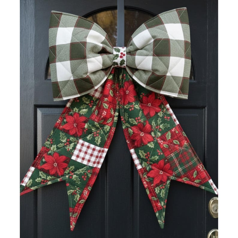 May include: A large quilted fabric bow featuring a green and white buffalo check pattern on the top loops and a festive red poinsettia and holly leaf print on the long hanging tails, with a small center band decorated with holly berries.